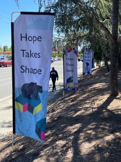 banners with messages of hope along Stevens Creek Boulevard