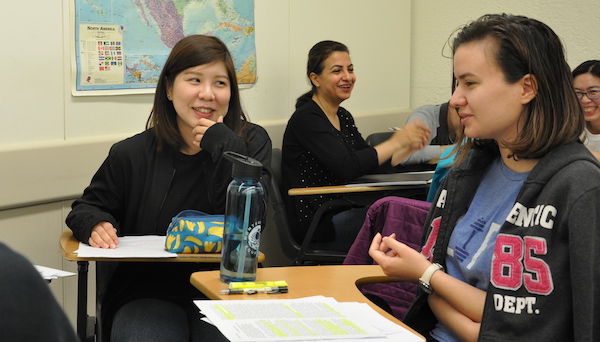 young women talking in class