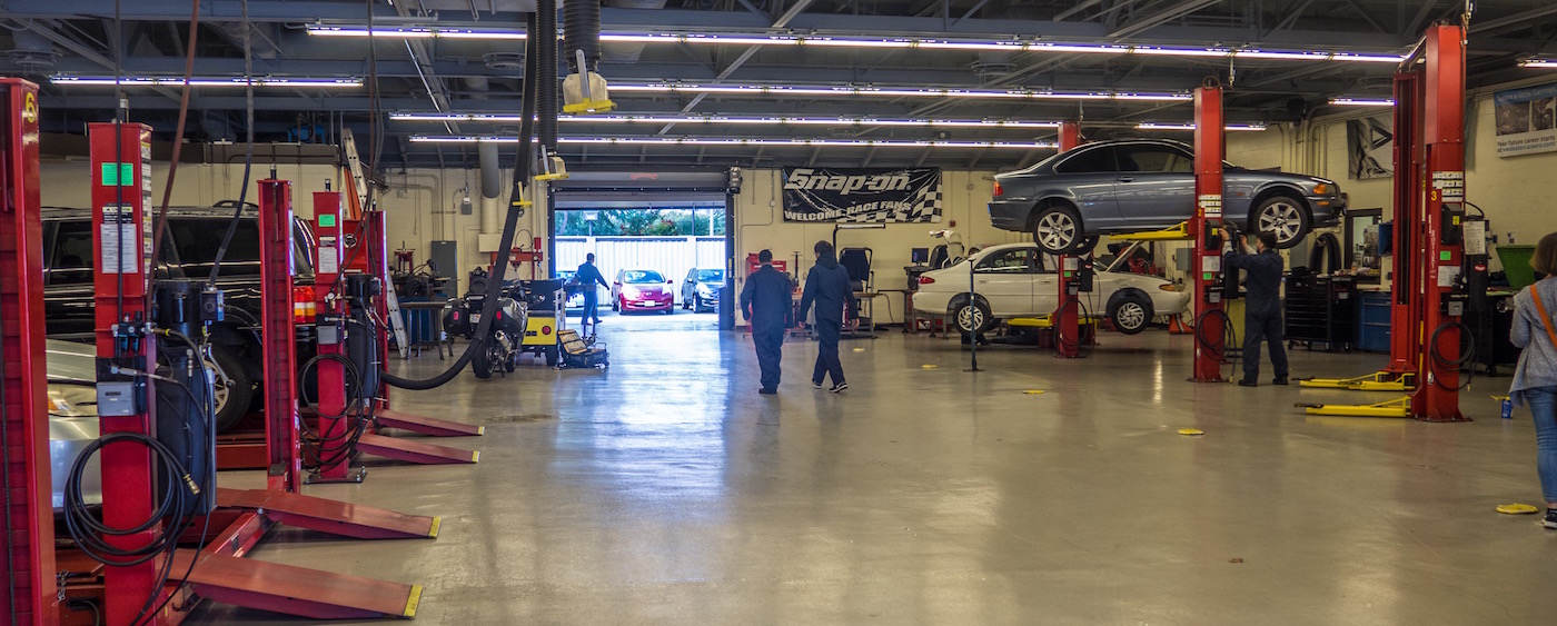 auto tech garage with two students walking away