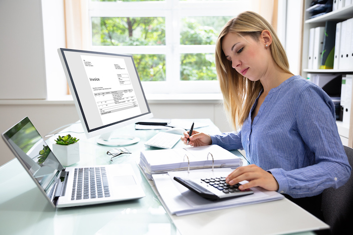 woman at desk with calculator