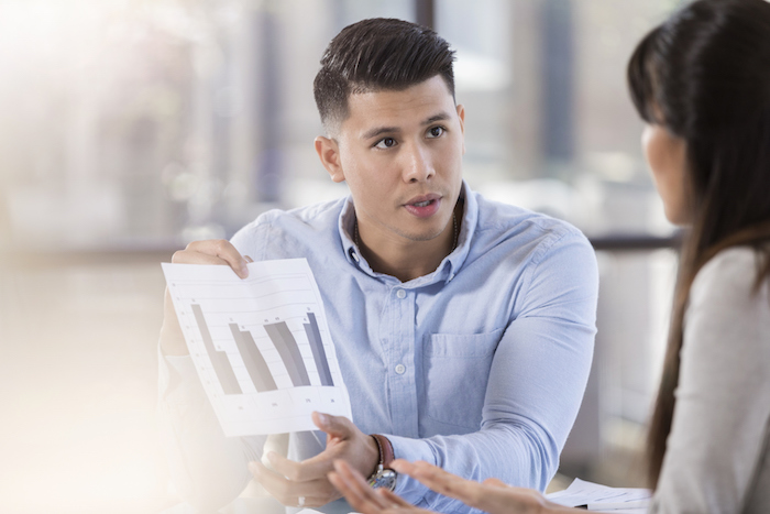 guy showing chart to woman