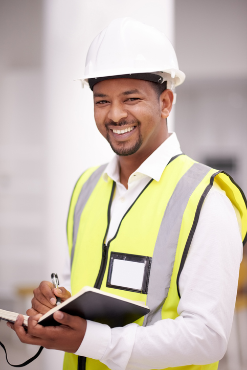 young man in hard hat and yellow vest