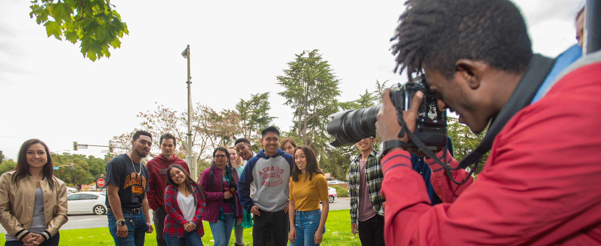 student in red jacket photographing other students