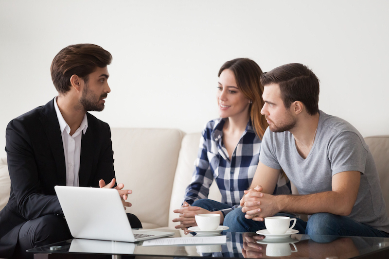 young man talking to couple