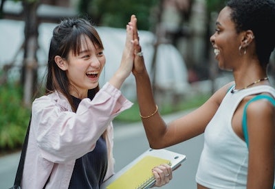 two young women doing high five