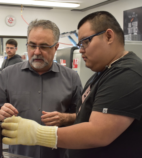 student and instructor at Haas machine