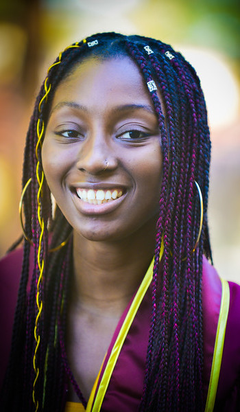 smiling young woman with colorful braids