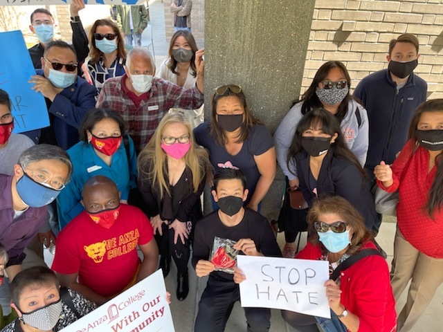 College and elected leaders holding signs against racism