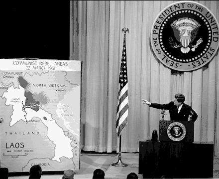 President John Kennedy pointing to a large map of Vietnam