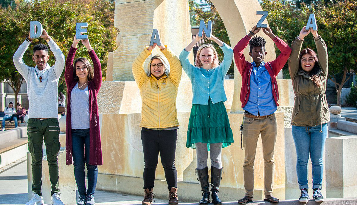 students holding letters that spell De Anza