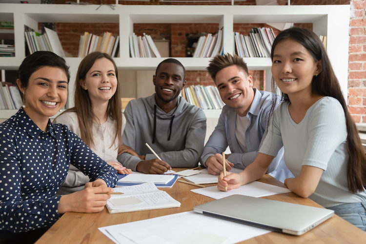 students smiling around table