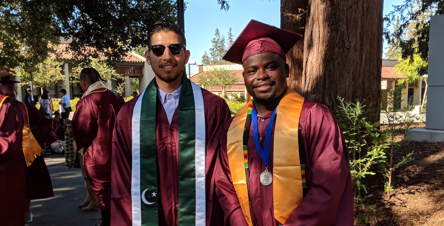 two smiling grads