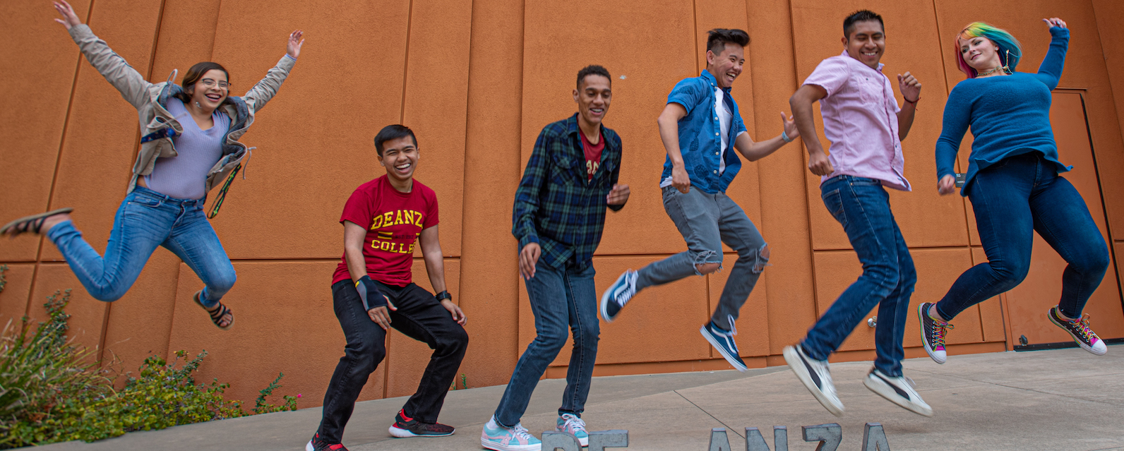 students in a line, some in mid-air