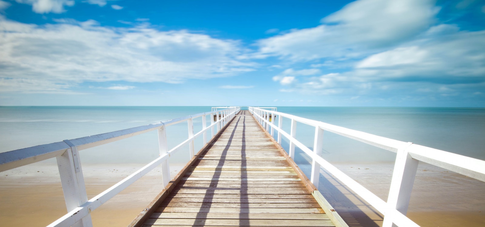 view of bridge across wide water