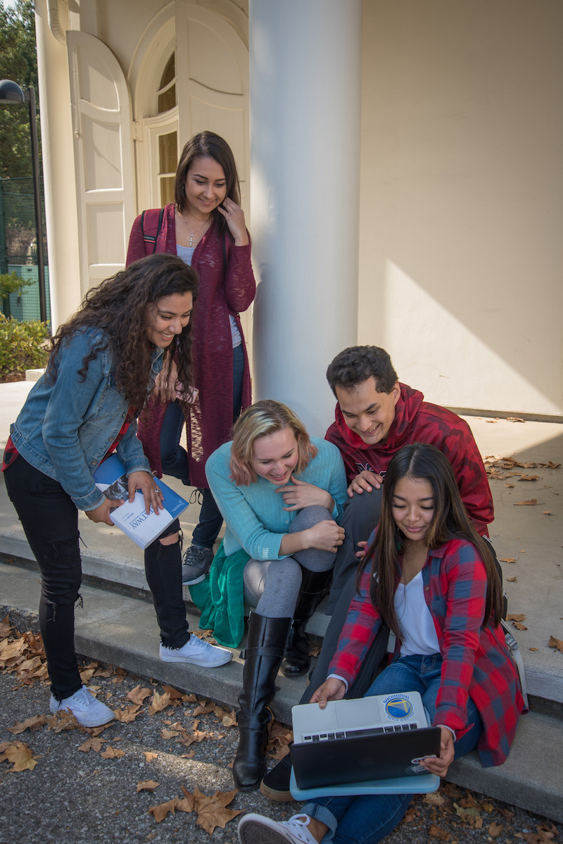 students looking at laptop