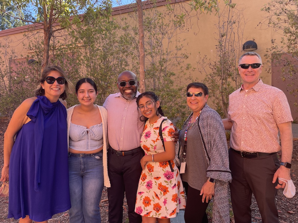 students with instructors and college president