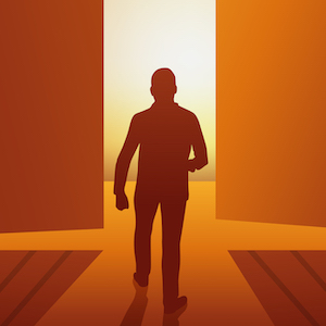silhouette of man walking into open doorway