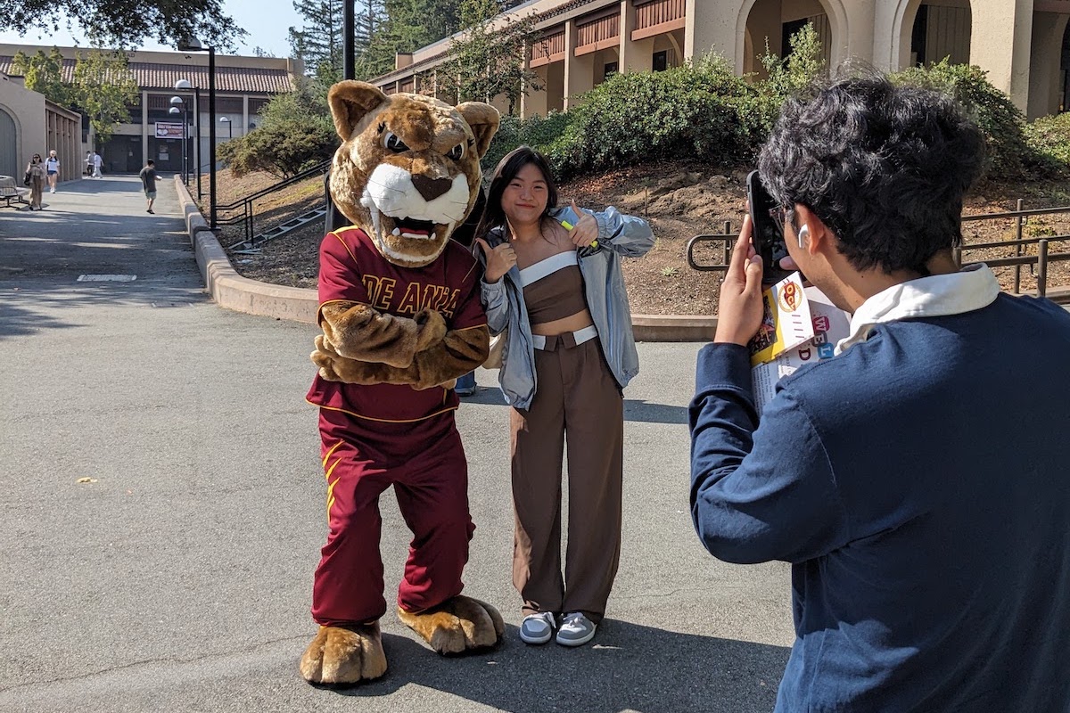 Roary and young woman posing for photographer