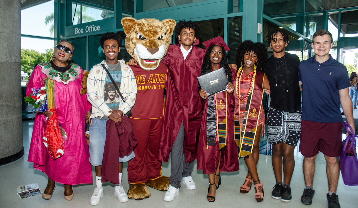 line of smiling grads with Roary