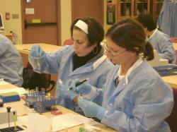 Two femal students working with tubes