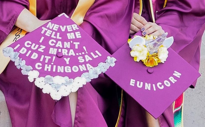 Yaneth and Eunice holding their graduation caps