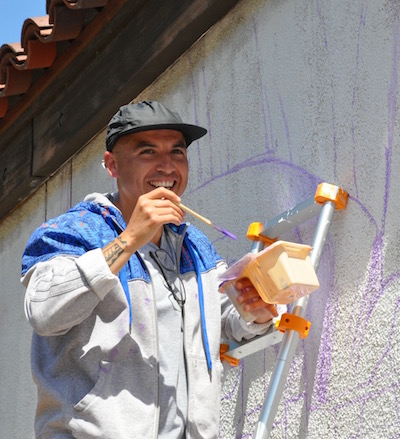 Muralist Sam Rodriguez at work