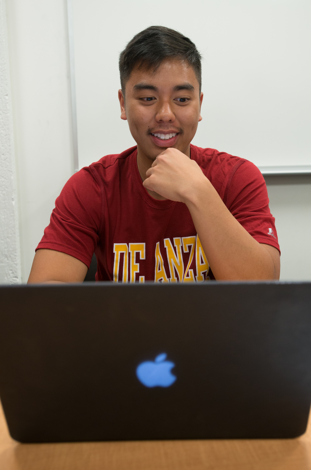 young man looking at laptop 