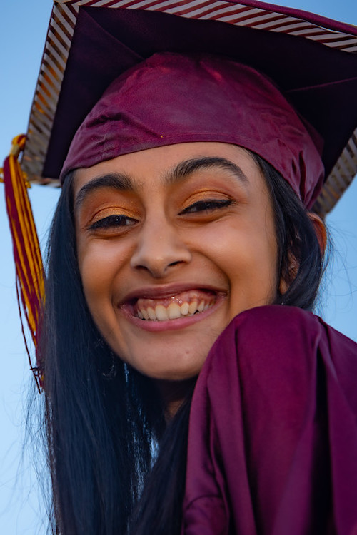 young woman in grad cap with big smile