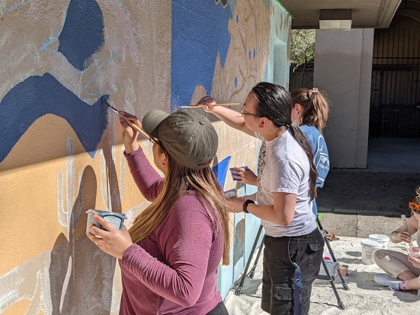 students painting mural