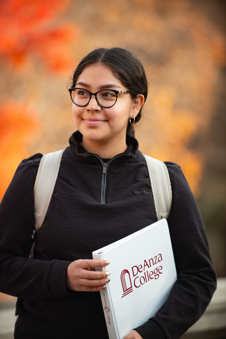 young woman with De Anza binder