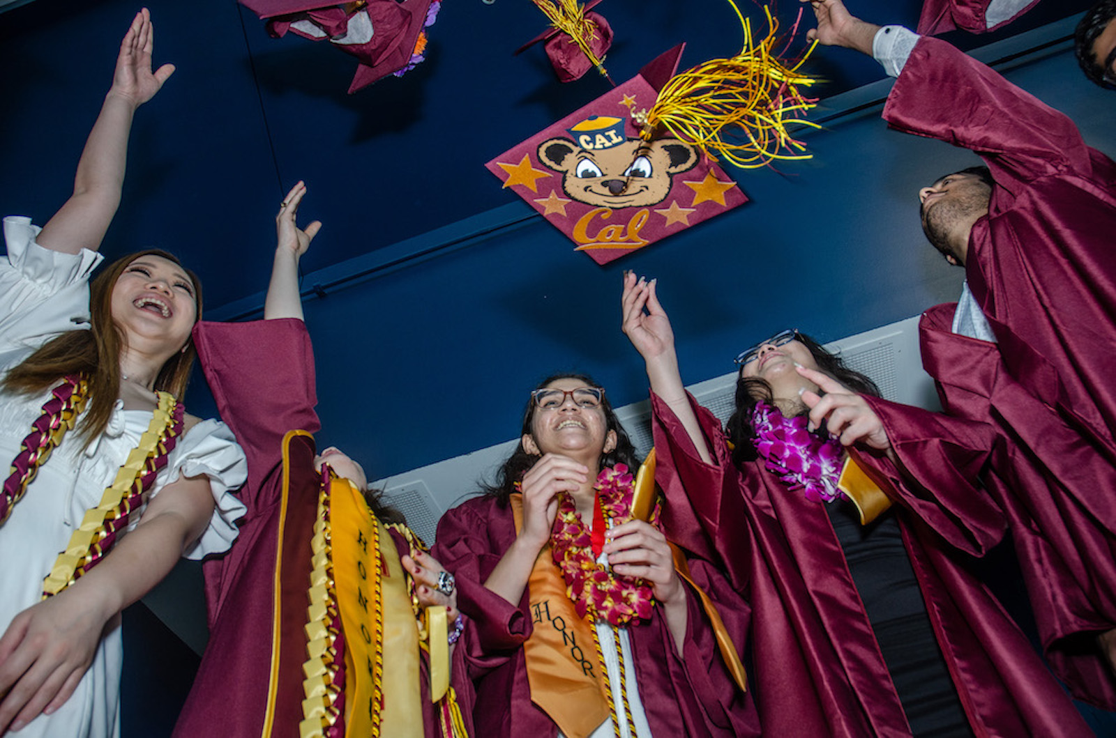 grads tossing Cal cap in air