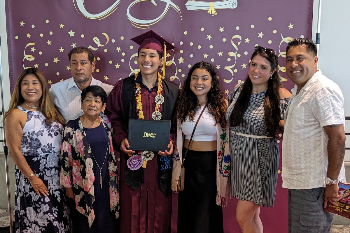 smiling grad with family members