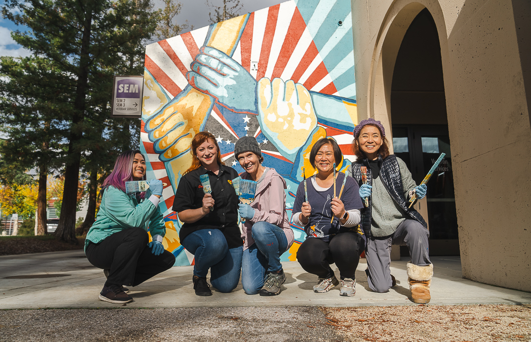 students in front of mural