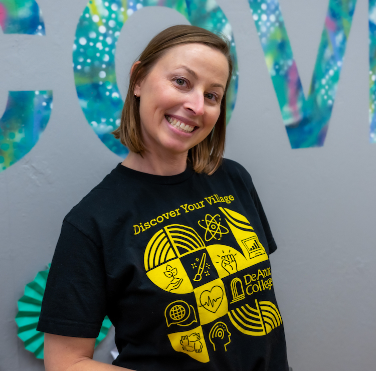 smiling woman wearing black T-shirt with Villages design