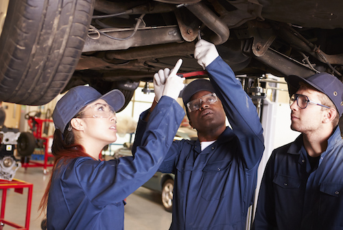 students working under car