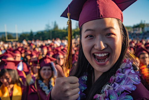grad giving thumbs up