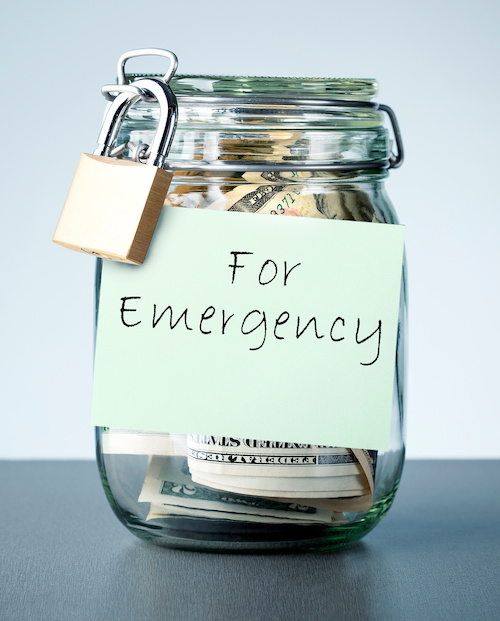 glass jar containing paper money, with padlock on jar lid