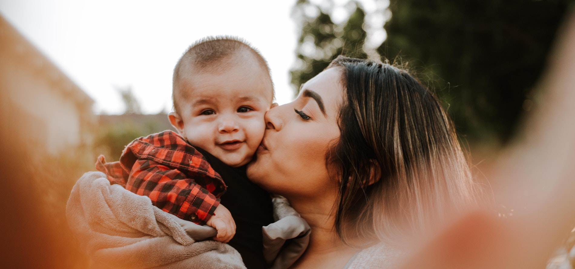 mother kissing baby