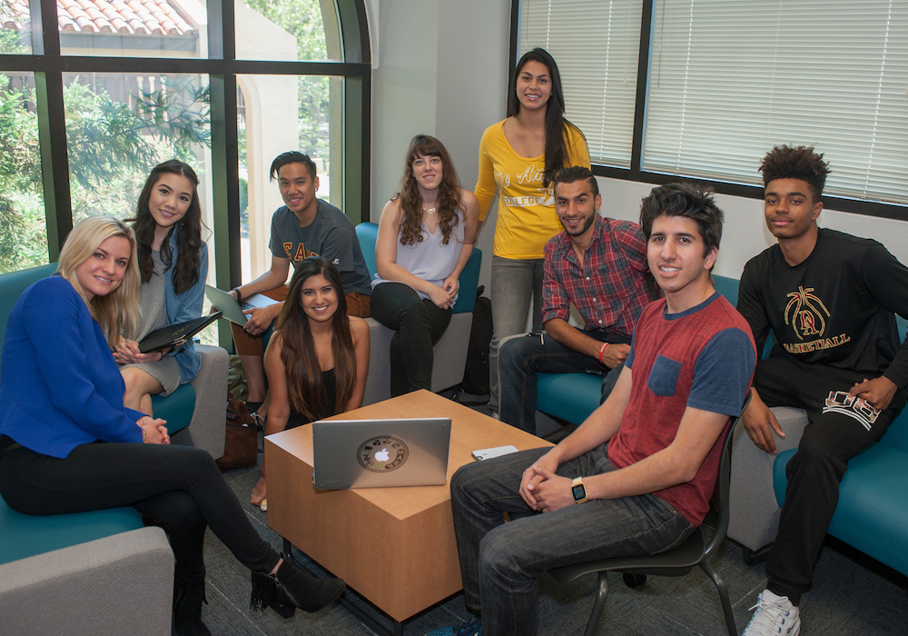 students sitting in group with laptop