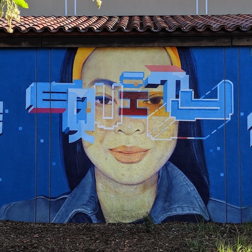 section of mural showing woman's face and the word "Equity"