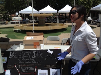 Female student with her black ink project