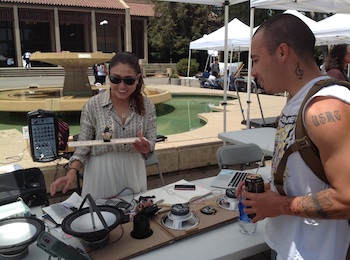 Female student explaining how to harvest energy from sound waves to a male students.