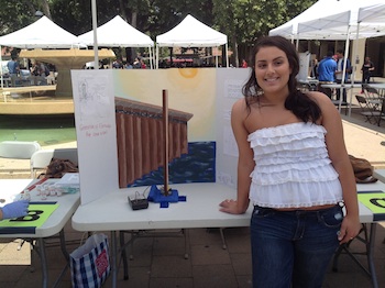 Female student at fair with ocean pier generator