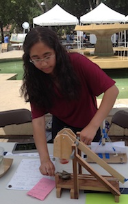 Female student setting up the trebuchet for a launch.